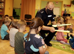 policjant rozdaje dzieciom odblaski