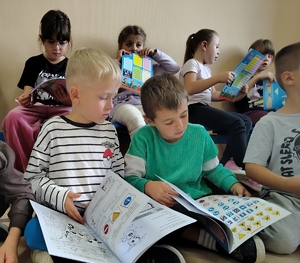 chłopcy oglądają książeczkę