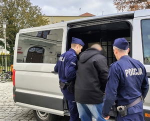 policjanci prowadzą zatrzymanego