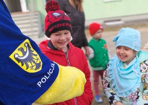 grupa dzieci przy policyjnym radiowozie i maskotce