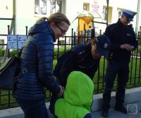 Policjanci rozdają dzieciom i rodzicom odblaski i odznaki &quot;Jestem bezpieczny – jeżdżę w foteliku&quot;